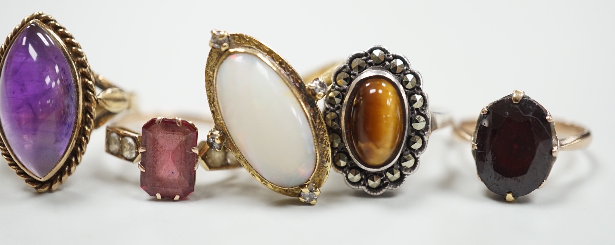 An 18ct, white opal and diamond chip set oval dress ring, size M, gross 4.8 grams and three other assorted 9ct gold and gem set dress rings, gross 10.3 grams and a white metal ring.